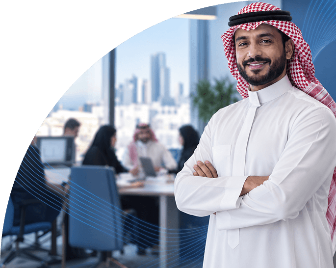 موظف سعودي يقف بثقة في مكتب حديث